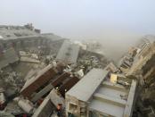 Rescue personnel work on damaged buildings after an earthquake in Tainan, southern Taiwan, February 6, 2016. REUTERS/Pichi Chuang