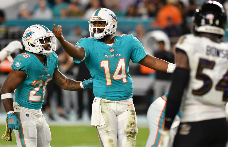 Miami Dolphins quarterback Jacoby Brissett (14) directs his offense against the Baltimore Ravens during the first half of an NFL game at Hard Rock Stadium in Miami Gardens, Nov. 11, 2021. 