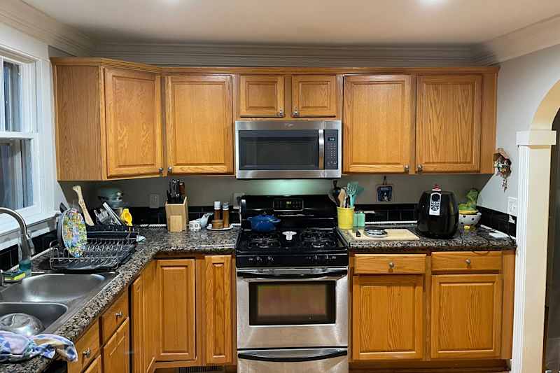 Wooden cabinets in kitchen before renovation.