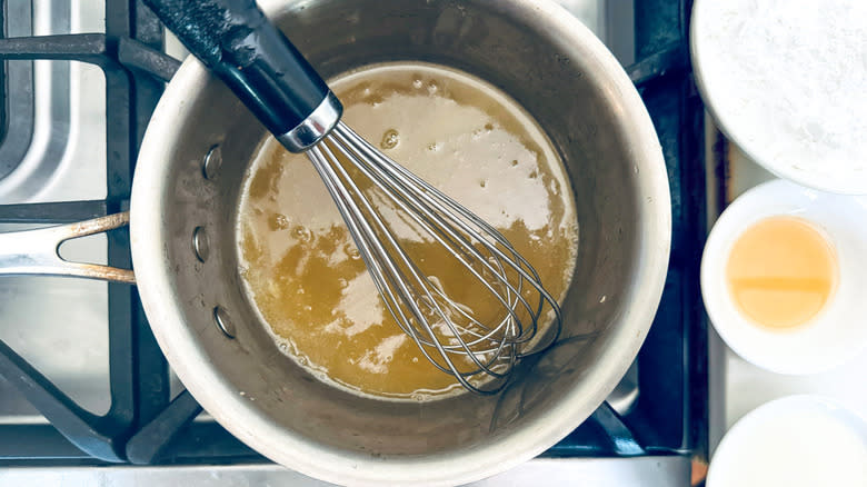 liquid and whisk in saucepan