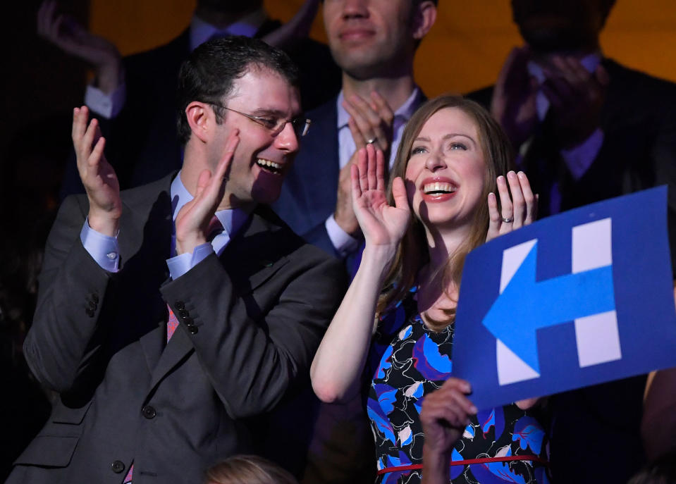 Chelsea Clinton, daughter of Democratic Presidential candidate Hillary Clinton and husband Marc Mezvinsky smile as Democratic Presidential candidate Hillary Clinton appears on screen live during the second day of the DNC in Philadelphia , Tuesday, July 26, 2016. (Photo: Mark J. Terrill/AP)