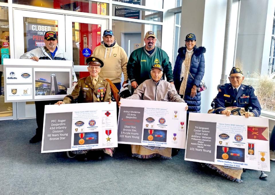 Three area World War II veterans are pictured with their escorts at the Patriots Hall of Fame at Gillette Stadium before the Army-Navy game on Dec. 9. Seated, from left, are Roger Desjardins of North Providence, Arthur Mederois of Bristol and Caster Salemi of North Attleboro, who were able to attend the game largely through the efforts of John Cianci, standing, left, of the Rhode Island chapter of Italian American Veterans of the United States.