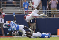 Arkansas quarterback KJ Jefferson (1) is upended by Mississippi linebacker Mark Robinson (35) as he scores a touchdown during the second half of an NCAA college football game, Saturday, Oct. 9, 2021, in Oxford, Miss. Mississippi won 52-51.(AP Photo/Rogelio V. Solis)