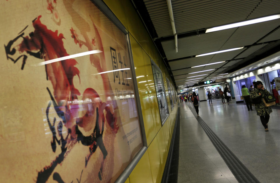 In this Tuesday, Jan. 28, 2014 photo, a Chinese New Year poster is displayed at a subway station in Hong Kong. Chinese communities around the world were welcoming the arrival of the year of the horse on Friday, Jan. 31 with equine-themed decorations and celebrations. The annual Lunar New Year holiday is mark with particular verve in Hong Kong, the semi-autonomous Chinese financial center that expects 7.93 million visitors, more than territory’s permanent population of 7.1 million. (AP Photo/Vincent Yu)