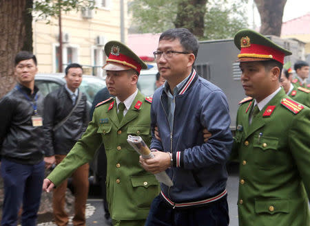 PVC's former chairman Trinh Xuan Thanh (C) is escorted by police to the court in Hanoi, Vietnam January 8, 2018. Mandatory credit VNA/Doan Tan via REUTERS