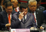 Philippine President Rodrigo Duterte listens to the statement of Chinese Premier Li Keqiang during the ASEAN Plus China Summit in the ongoing 33rd ASEAN Summit and Related Summits Wednesday, Nov. 14, 2018, in Singapore. (AP Photo/Bullit Marquez)