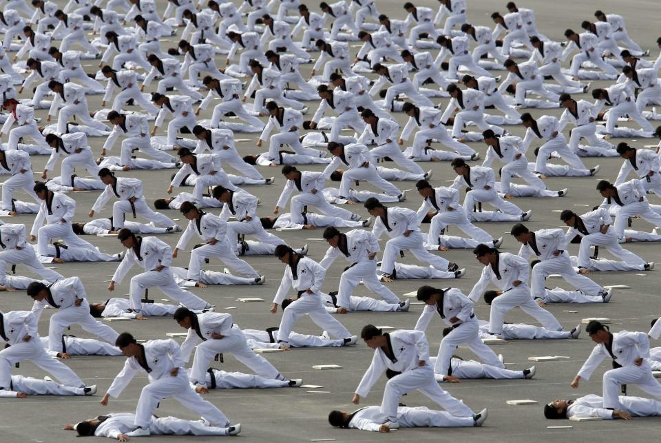 Members of the Special Warfare Command give a demonstration of their skills in the traditional Korean martial art of taekwondo during celebrations to mark the 65th anniversary of Korea Armed Forces Day, at a military airport in Seongnam, south of Seoul, October 1, 2013. (REUTERS/Kim Hong-Ji)