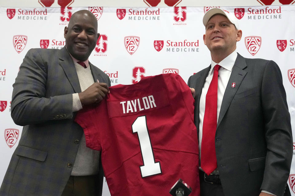 Bernard Muir, left, athletic director at Stanford, and Troy Taylor, right, Stanford's new head NCAA college football coach, pose for a photo during a news conference, Monday, Dec. 12, 2022, in Stanford, Calif. (AP Photo/Tony Avelar)