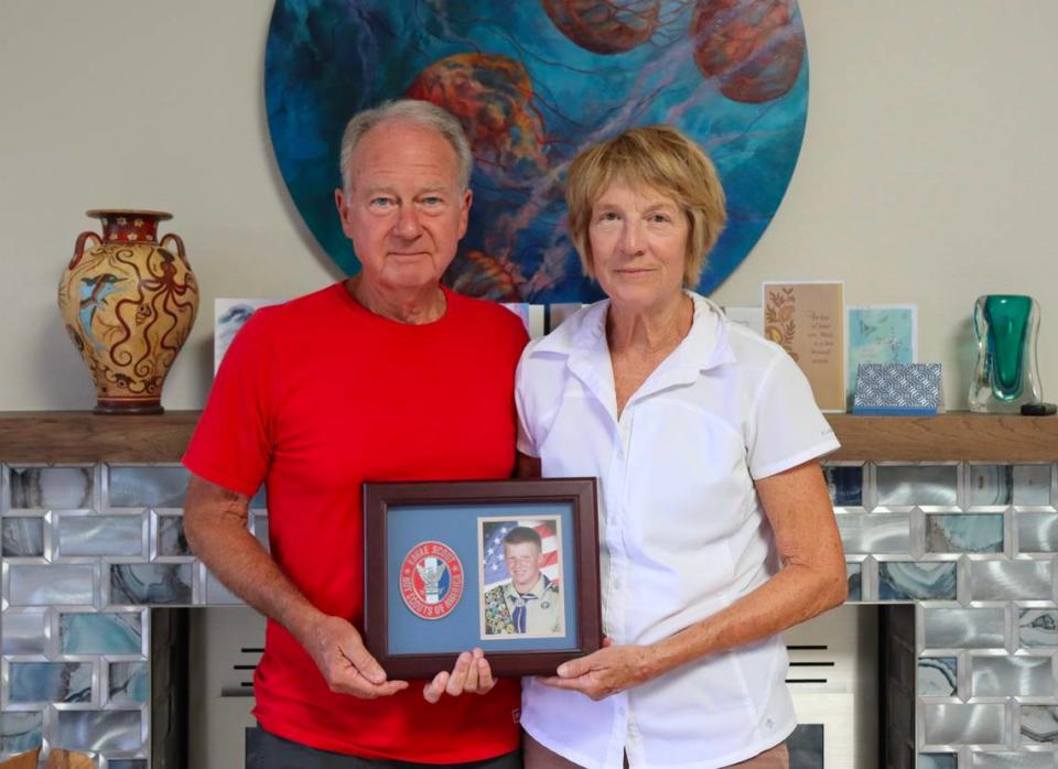 Marc and Becky Bowen hold a picture of their son, Matthew Bowen, in his high school Eagle Scout uniform on July 18, 2024 in Pismo Beach. Bowen, 32, died after being hit by a suspected DUI driver in Vacaville on July 11, 2024. 