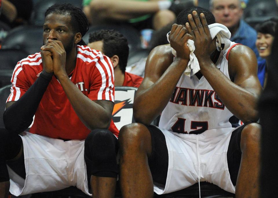 Atlanta Hawks' Elton Brand (42) and DeMarre Carroll sit on the bench as time runs out in the second half of their NBA basketball game against the Portland Trail Blazers Thursday, March 27, 2014, in Atlanta. Portland won 100-85. (AP Photo/David Tulis)