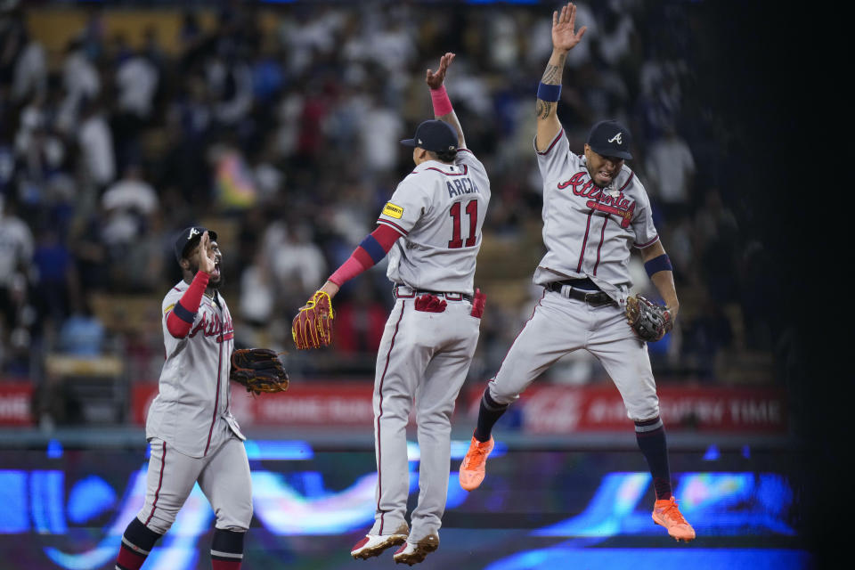 Atlanta Braves' Michael Harris II, Orlando Arcia and Eddie Rosario, from left, celebrate the team's 4-2 win over the Los Angeles Dodgers in 10 innings in a baseball game Saturday, Sept. 2, 2023, in Los Angeles. (AP Photo/Jae C. Hong)