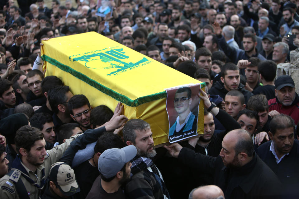 Mourners carry the coffin of Ali Khadra, who was killed Thursday by a bomb explosion, during his funeral procession in the southern suburb of Beirut, Lebanon, Saturday, Jan. 4, 2014. An explosion tore through a crowded commercial street Thursday in a south Beirut neighborhood that is bastion of support for the Shiite group Hezbollah, killing several people, setting cars ablaze and sending a column of black smoke above the Beirut skyline. (AP Photo/Hussein Malla)