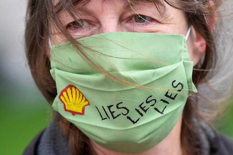 A slogan is seen on a protective face mask of an Extinction Rebellion climate action group protester as she demonstrates against multinational gas and oil firm Shell in London last month. (Photo: Toby Melville / Reuters)