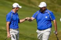 Team Europe's Shane Lowry is congratulated by Team Europe's Rory McIlroy after making a putt on the fourth hole during a four-ball match the Ryder Cup at the Whistling Straits Golf Course Friday, Sept. 24, 2021, in Sheboygan, Wis. (AP Photo/Jeff Roberson)