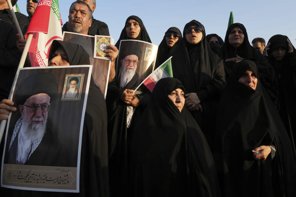 File - Iranian pro-government demonstrators hold posters of the Supreme Leader Ayatollah Ali Khamenei during their rally condemning recent anti-government protests over the death of Mahsa Amini, a 22-year-old woman who had been detained by the nation's morality police, in Tehran, Iran, Sunday, Sept. 25, 2022. (AP Photo/Vahid Salemi, File)