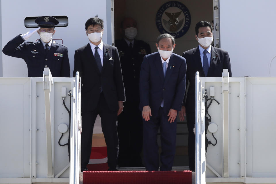 Japanese Prime Minister Yoshihide Suga boards his plane to depart at Andrews Air Force Base, Md., Saturday, April 17, 2021, after his visit to Washington. (AP Photo/Luis M. Alvarez)