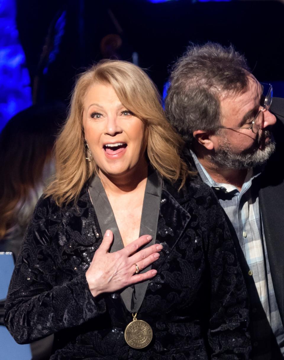 Inductee Patty Loveless reacts to the unveiling of her hall of fame plaque with presenter Vince Gill during the 2023 Country Music Hall of Fame induction ceremony Sunday, October 22, 2023.