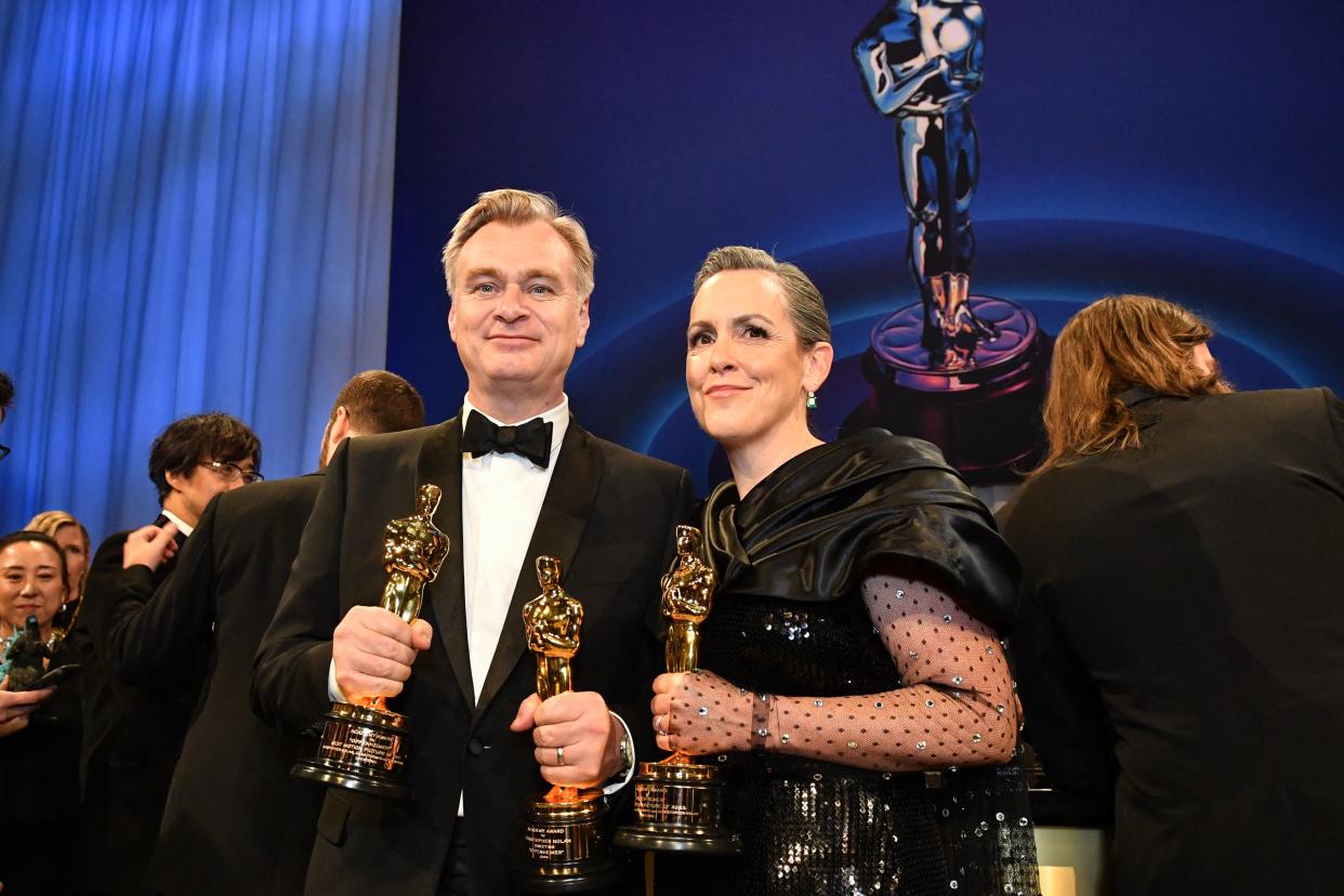Christopher Nolan and producer Emma Thomas hold their Oscars for "Oppenheimer."