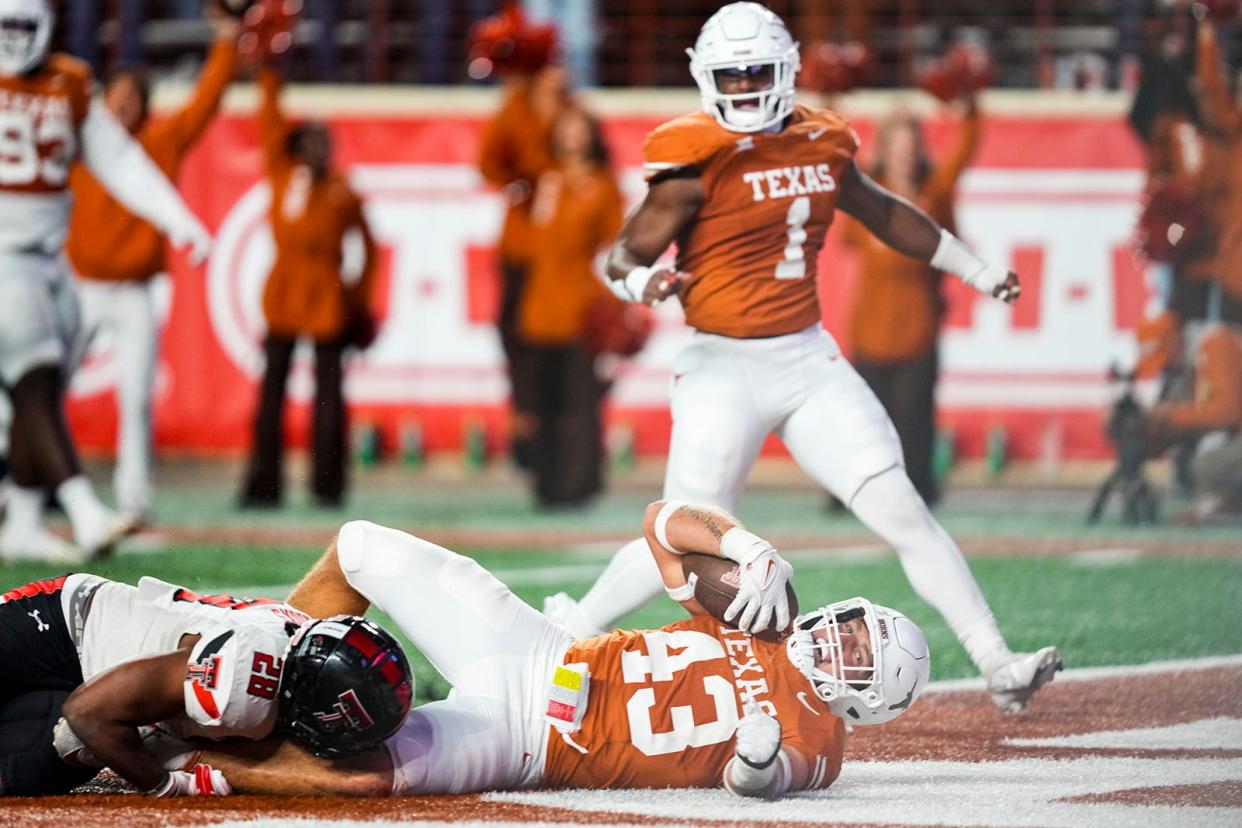 Texas linebacker Jett Bush scores on a 43-yard pick-six touchdown during Friday night's 57-7 win over Texas Tech. Bush, playing in his final home game, produced a sack, an interception and a touchdown.