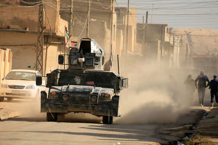 A military vehicle of Iraqi security forces is seen at Hammam al-Alil, south of Mosul, during a battle with Islamic State militants, Iraq November 6, 2016. REUTERS/Thaier Al-Sudani