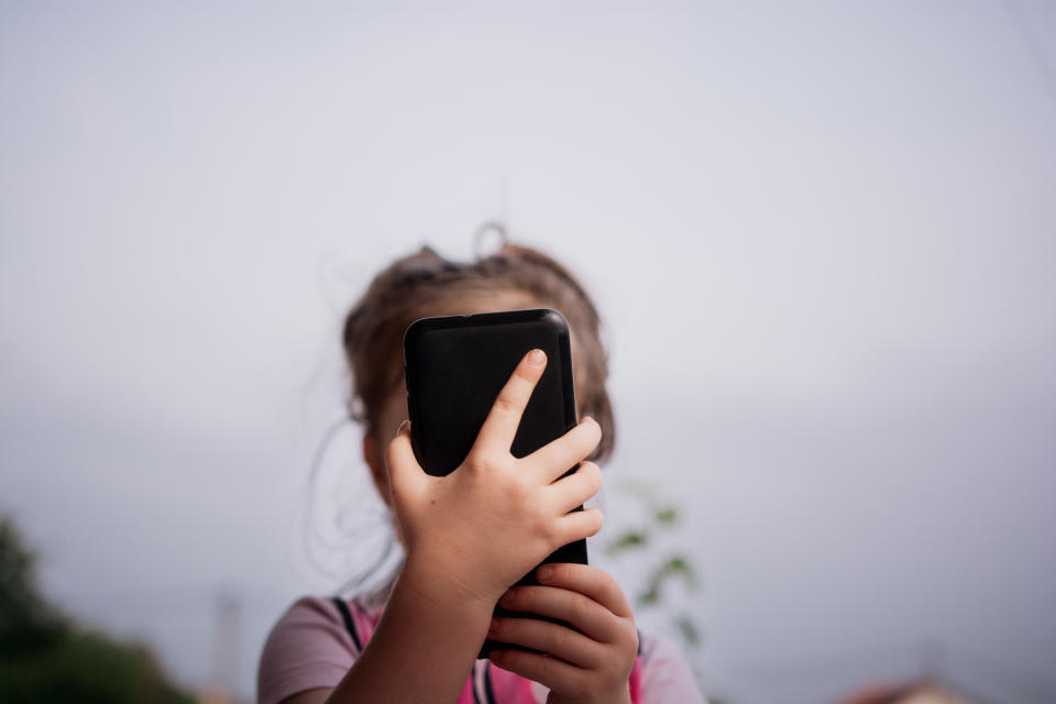 Child using a mobile phone. (Getty Images)