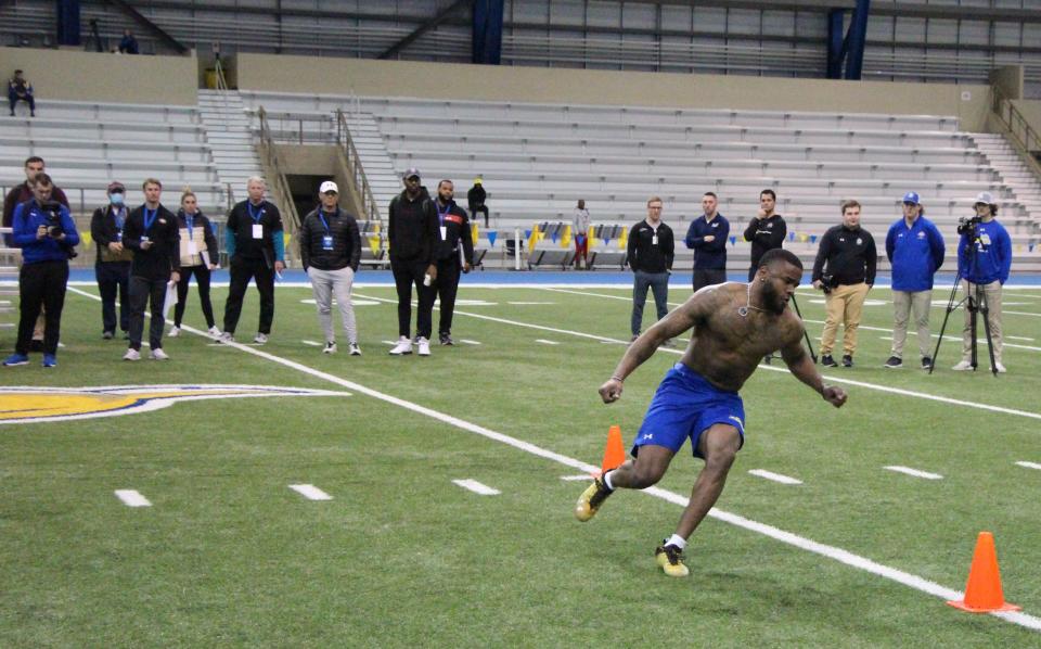 Pierre Strong runs through the cone drill while NFL scouts watch during Wednesday's South Dakota State football Pro Day