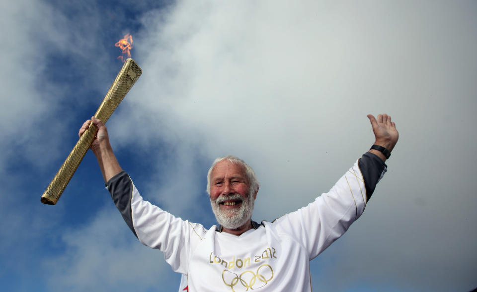 Sir Chris Bonington holds the Olympic torch on the summit of Mount Snowdon on May 29, 2012 in Llanberis, United Kingdom. Legendary mountaineer Sir Chris Bonington, aged 77, was given the honour of carrying the torch to the summit of Wales's highest mountain, the place his climbing career began 61 years ago. The Olympic Flame is now on day 11 of a 70-day relay involving 8,000 torchbearers covering 8,000 miles. (Photo by Christopher Furlong/Getty Images)