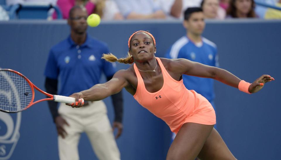 Sloane Stephens, from the United States, reaches to return the ball during a match against Maria Sharapova, from Russia, at the Western & Southern Open tennis tournament, Tuesday, August 13, 2013, in Mason, Ohio. (AP Photo/Michael E. Keating)