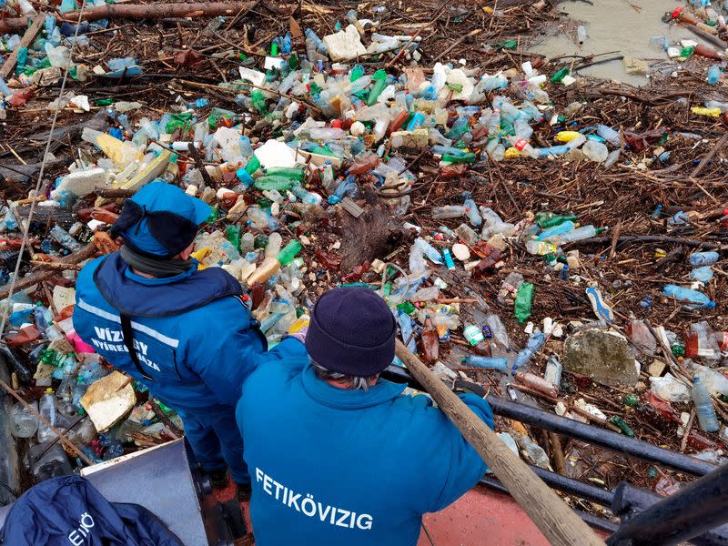 Workers collect plastic waste from Tisza river in Vasarosnameny