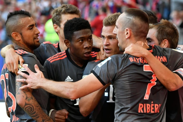 Bayern Munich's midfielder Joshua Kimmich (C) celebrates scoring with his teammates during their German first division Bundesliga football match against Hamburg SV on September 24, 2016