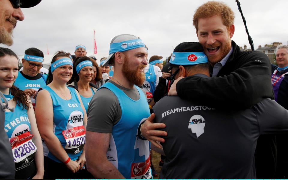 Prince Harry greets runners representing the charity 'Heads Together' - Credit: Luke MacGregor - WPA Pool/Getty Images