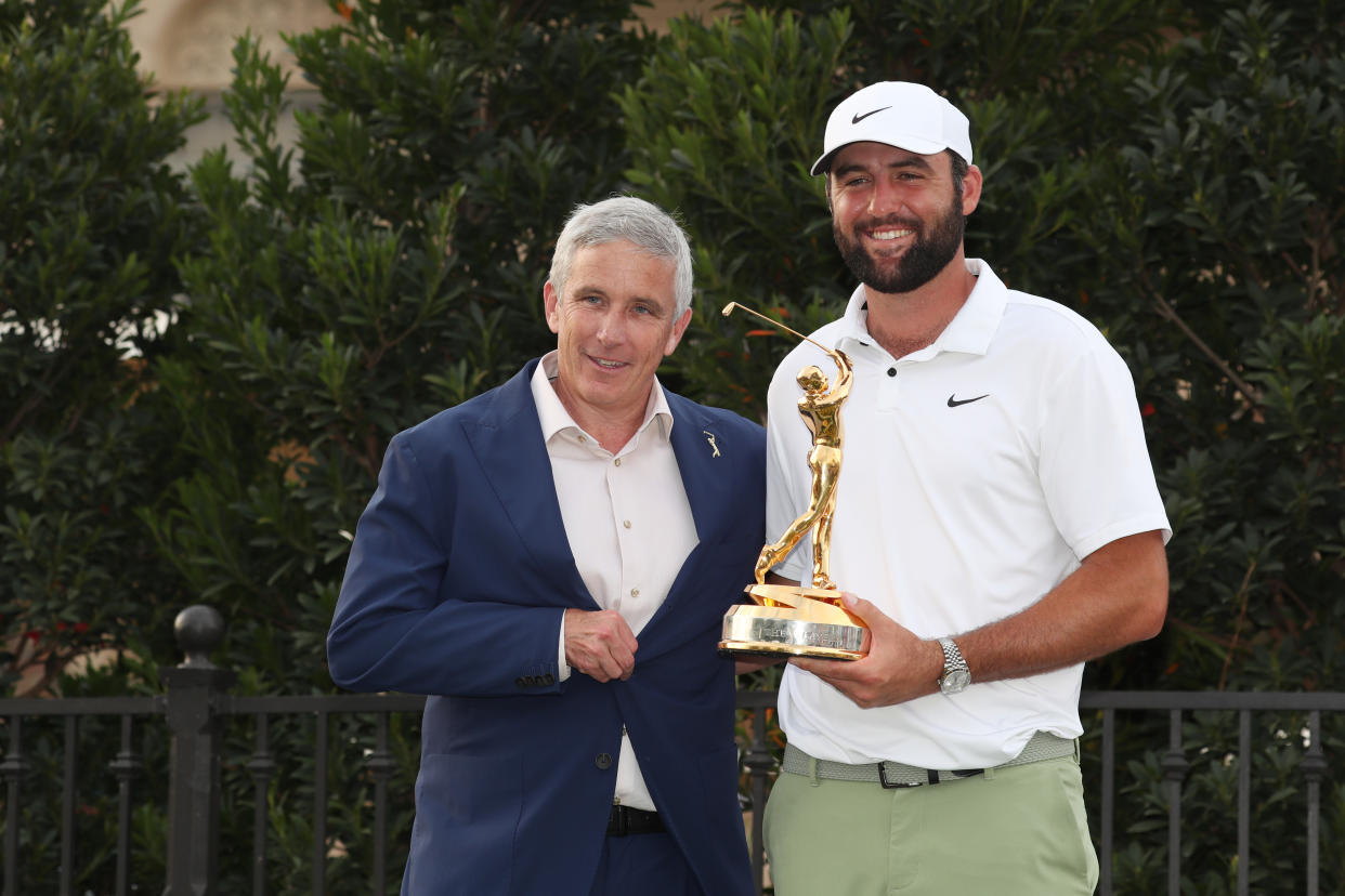 PGA Tour commissioner Jay Monahan, seen here with Players Championship winner Scottie Scheffler, says negotiations with Saudi Arabia's PIF are continuing. (Brian Spurlock/Icon Sportswire via Getty Images)