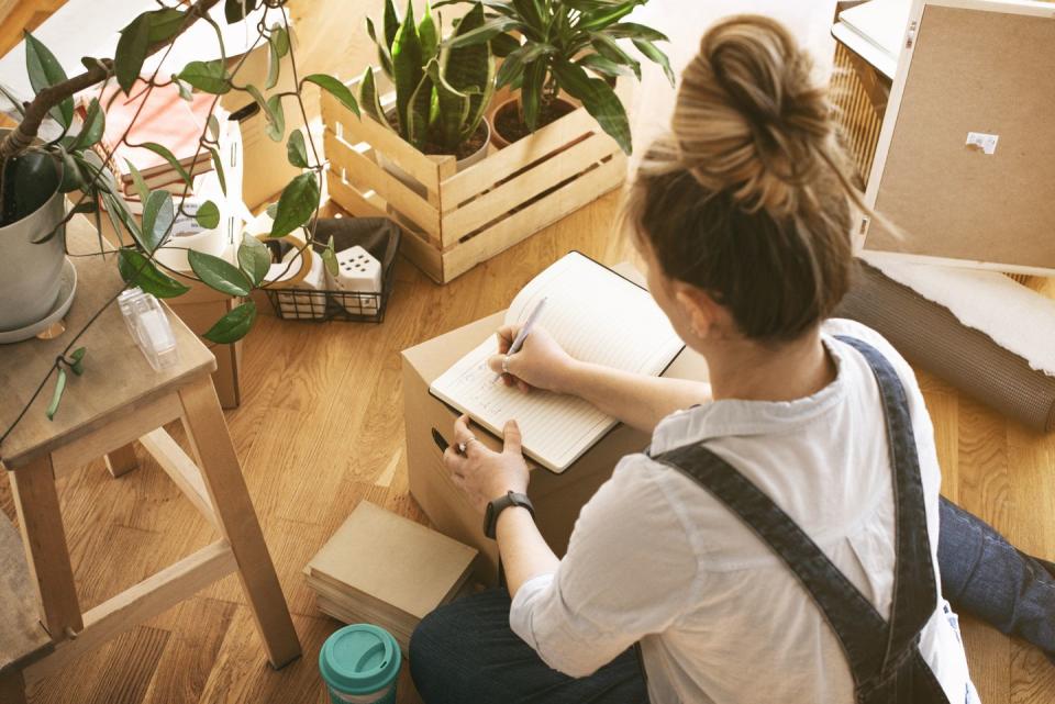 young woman moving in into new apartment