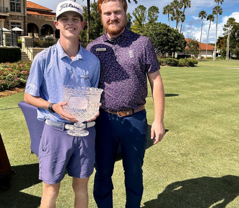 Hamilton Coleman of Augusta, Ga., accepts the Junior Players Championship trophy from Shane Miller, the events manager for the TPC Sawgrass pro staff. Coleman beat Blades Brown in a two-hole playoff on Sept. 1 at the Players Stadium Course at TPC Sawgrass.