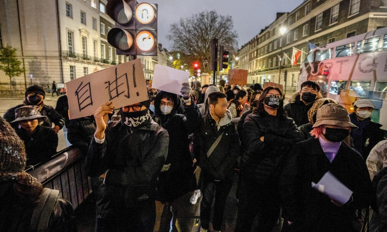<span>Chinese students hold a placard reading freedom (自由) at a march in London after 10 people died in a building fire during a strict Covid lockdown in Urumqi, China, December 2022.</span><span>Photograph: SOPA Images/LightRocket/Getty Images</span>