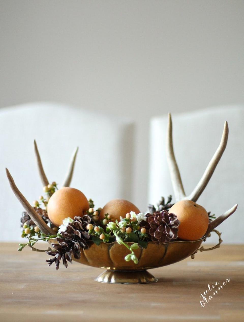<p>The best thing about this centerpiece (other than the antlers) is that it only takes five minutes to set up.</p><p><strong>Get the tutorial at <a rel="nofollow noopener" href="https://julieblanner.com/5-minute-thanksgiving-centerpiece/" target="_blank" data-ylk="slk:Julie Blanner.;elm:context_link;itc:0;sec:content-canvas" class="link ">Julie Blanner. </a></strong></p>