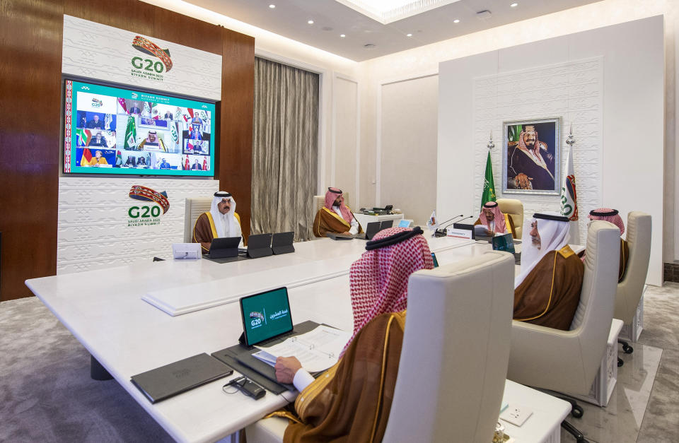 In this handout image provided by G20 Riyadh Summit, Saudi King Salman, top right, gives his opening remarks at a virtual G20 summit hosted by Saudi Arabia and held over video conference amid the COVID-19 pandemic, in Riyadh, Saudi Arabia, Saturday, Nov. 21, 2020. (G20 Riyadh Summit via AP)