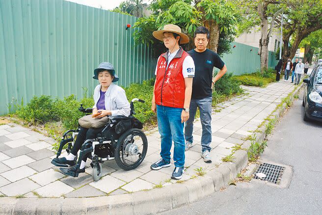 輪椅族高老師（左）與縣議員楊華美（中）、文化局長吳勁毅（右）等人18日實地前往文化局臨時圖書館，卻發現無障礙道路被施工圍籬「阻斷」。（王志偉攝）