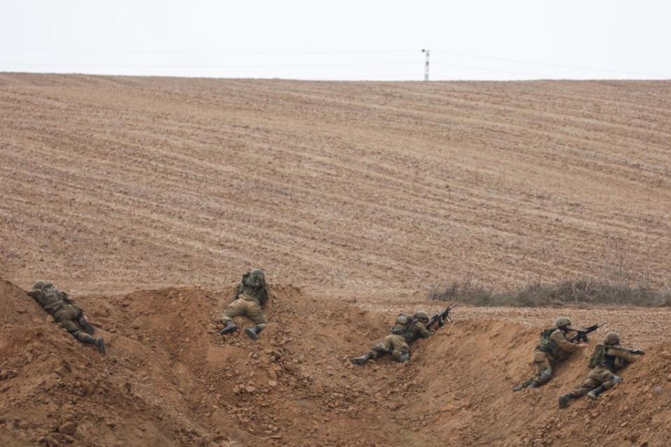 Israeli soldiers take up positions near the Israel-Gaza border.