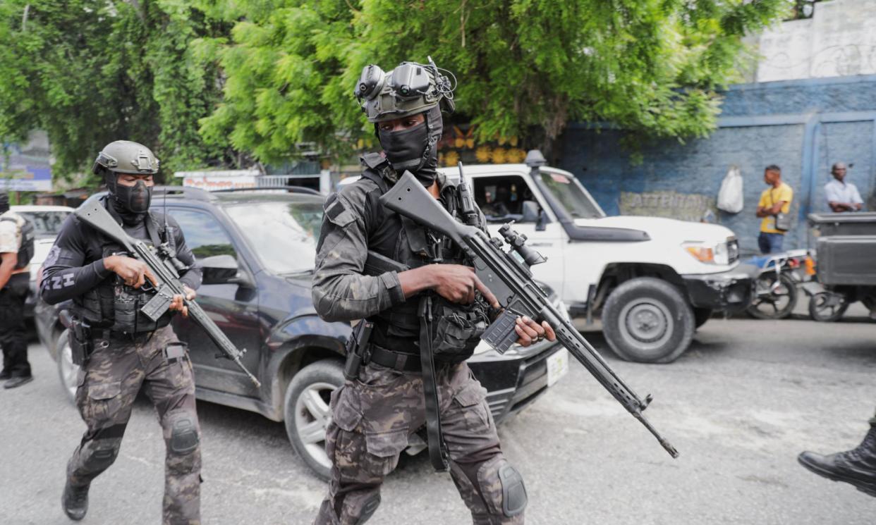 <span>Security personnel patrol Port-au-Prince near the presidential palace before the ceremony.</span><span>Photograph: Ralph Tedy Erol/Reuters</span>