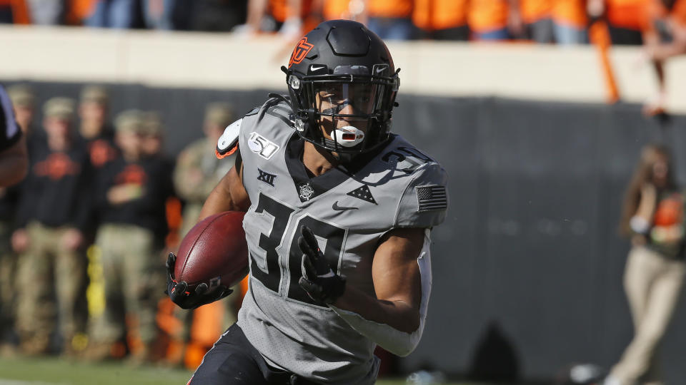 FILE - In this Saturday, Nov. 16, 2019, file photo, Oklahoma State running back Chuba Hubbard (30) carries against Kansas during an NCAA college football game in Stillwater, Okla., Saturday, Nov. 16, 2019. Oklahoma State has high hopes with Heisman contender Chuba Hubbard and star receiver Tylan Wallace. (AP Photo/Sue Ogrocki)