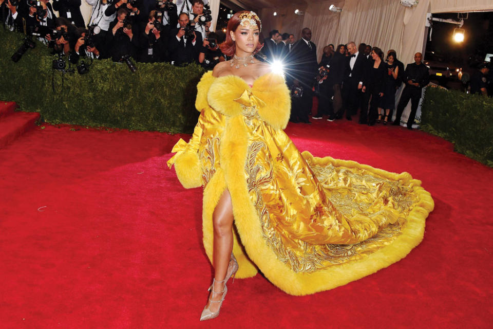 Rihanna on the red carpet wearing Guo Pei Couture with Christian Louboutin fall ’15 Toerless Muse strappy shoes. - Credit: Getty Images.