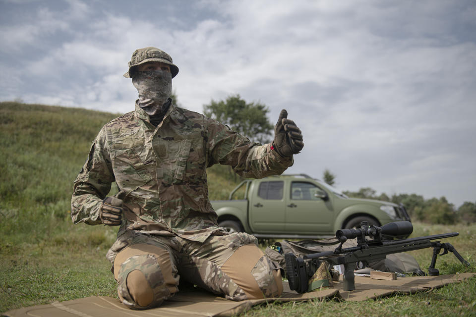 Ukrainian sniper Andriy speaks to The Associated Press during a training outside of Kyiv, Ukraine, Saturday, Aug. 27, 2022. After moving to Western Europe to work an an engineer, Andriy scrambled back to Ukraine at the start of the war, and within weeks underwent a conversion from civilian life to a sniper being trained by the country's special forces. (AP Photo/Andrew Kravchenko)