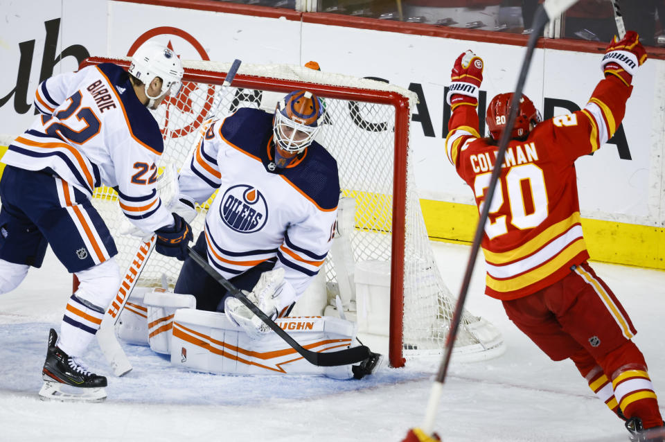 Edmonton Oilers goalie Mikko Koskinen, center, reacts as Calgary Flames forward Blake Coleman celebrates his goal during the second period of Game 1 of an NHL hockey second-round playoff series Wednesday, May 18, 2022, in Calgary, Alberta. (Jeff McIntosh/The Canadian Press via AP)