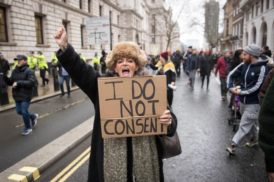 Image: A woman takes part in an anti-vaccination protest in Parliament Square, London. (Stefan Rousseau / PA Images via Getty Images file)