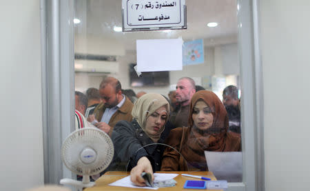 Palestinian Hamas-hired employees receive full salaries for the first time in years, in the southern Gaza Strip November 9, 2018. REUTERS/Ibraheem Abu Mustafa