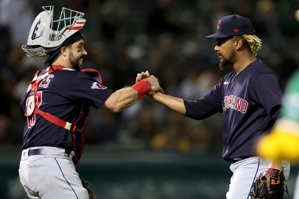 Cleveland Guardians relief pitcher Emmanuel Clase, right, and catcher Austin Hedges celebrate the team's victory over the Oakland Athletics in a baseball game in Oakland, Calif., Friday, April 29, 2022. (AP Photo/Jed Jacobsohn)