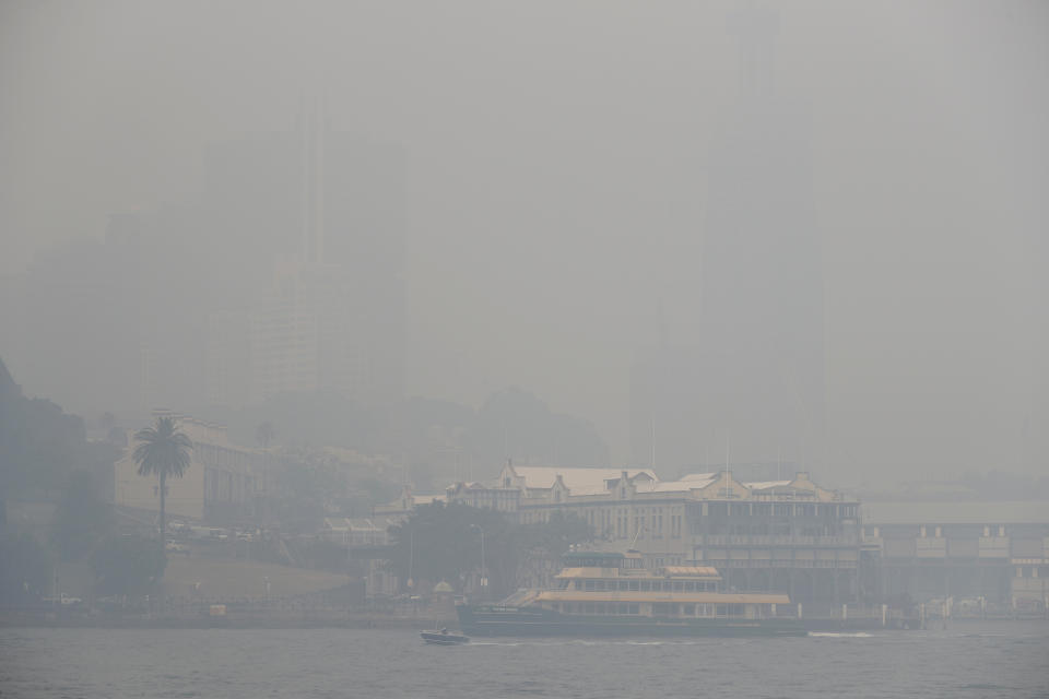 A ferry sails on the harbor as thick smoke settles in Sydney, Australia, Tuesday, Dec. 10, 2019. Hot dry conditions have brought an early start to the fire season. (AP Photo/Rick Rycroft)