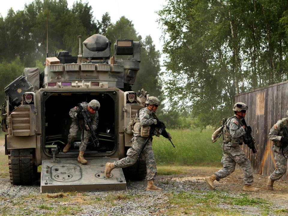 US soldiers dismount from their M2 Bradley Fighting vehicle during a fire team live-fire certification training as part of Exercise Combined Resolve II at the Joint Multinational Readiness Center in Hohenfels, Germany, June 17, 2014.