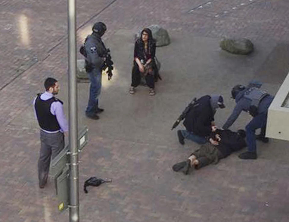 A person, on ground, being detained by police at Elizabeth Fry apartments in Barking, east London, which officers raided Sunday June 4, 2017, following Saturday's terror attack at London Bridge and Borough Market. Several people were killed in the terror attack at the heart of London and dozens injured.  (Furqan Nabi/PA via AP)